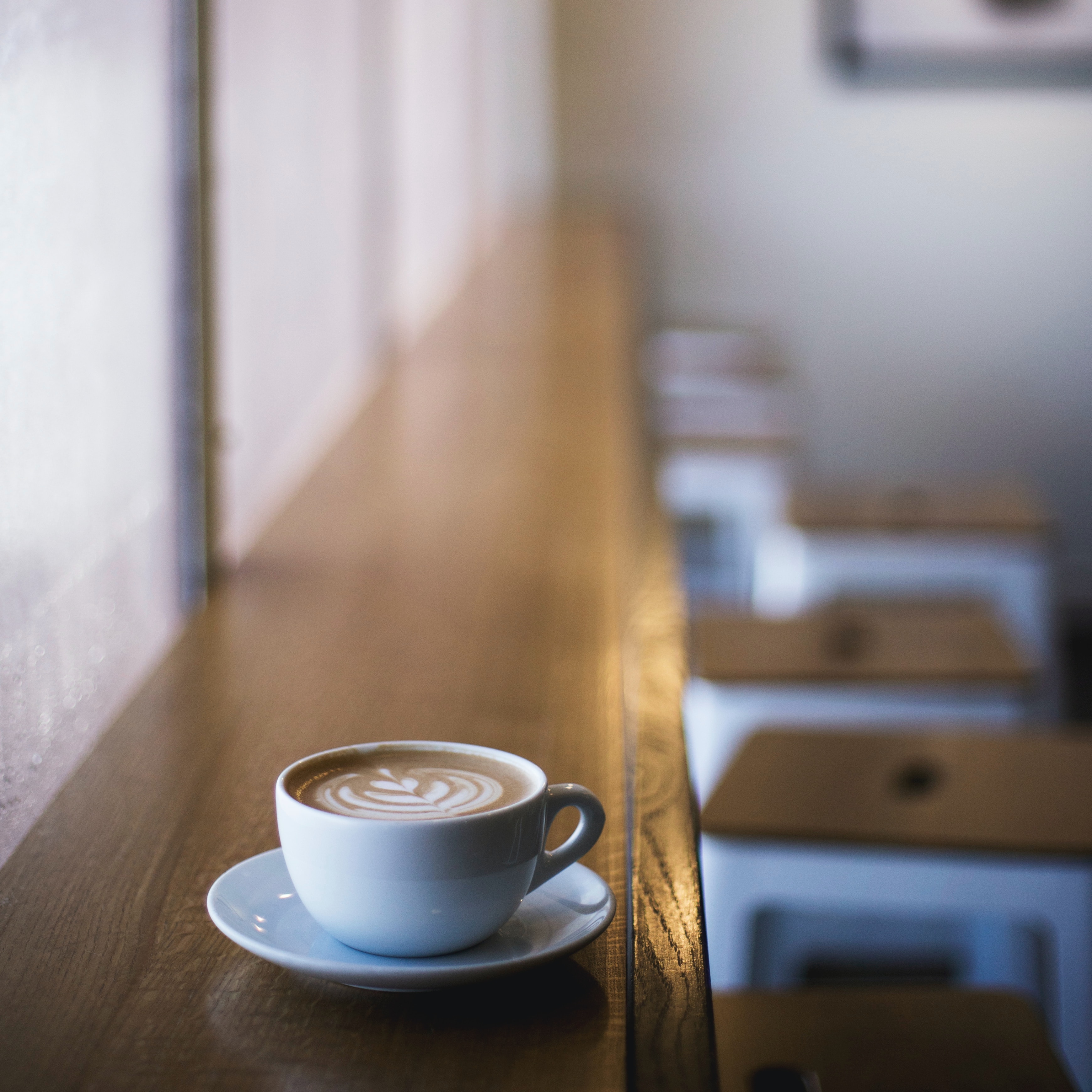 A mug of latte on the windowside countertop